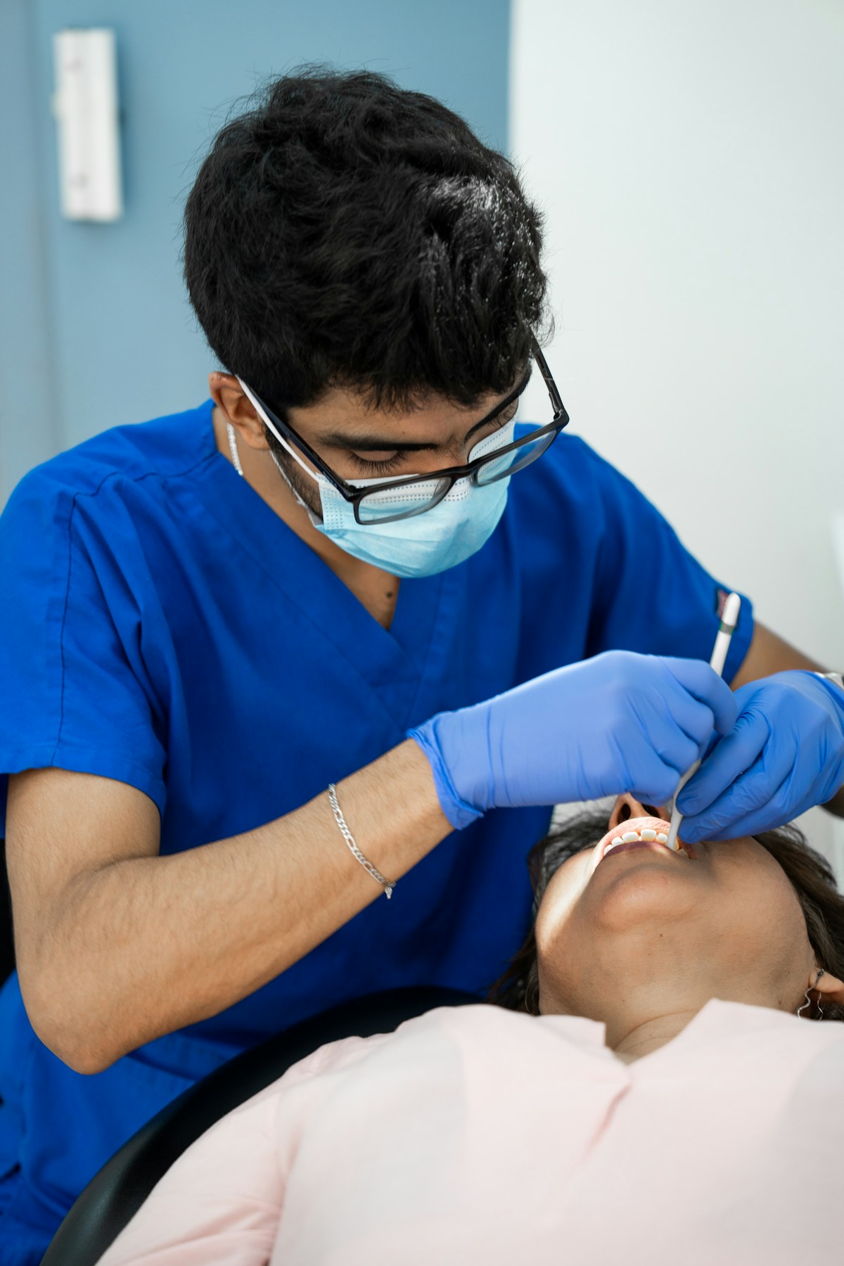 Dentist performing professional teeth scaling procedure